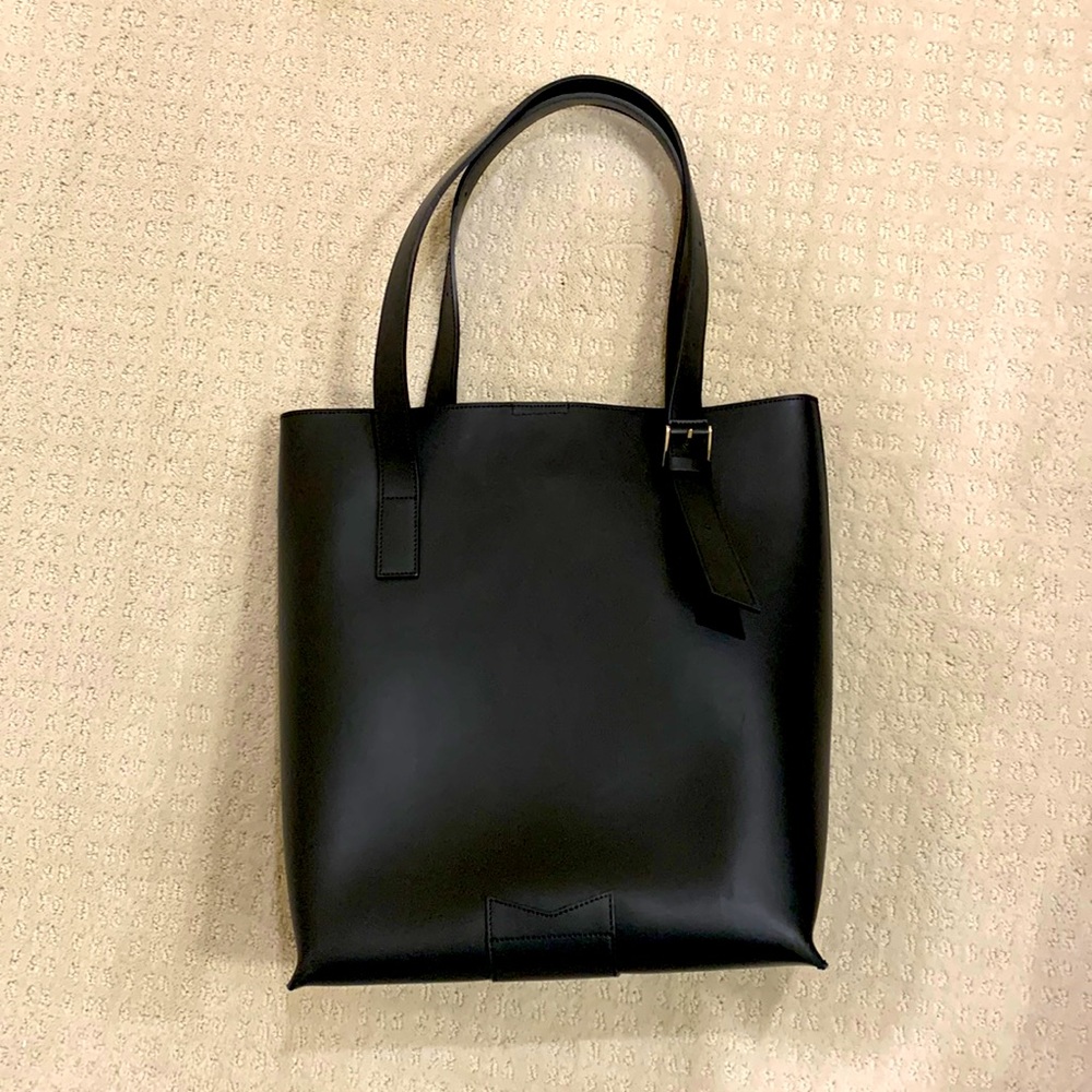 Black leather shoulder tote style bag.